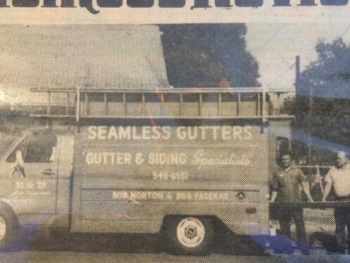 a picture of Jimmy's father and grandfather with their work van they used to install gutters and windows.